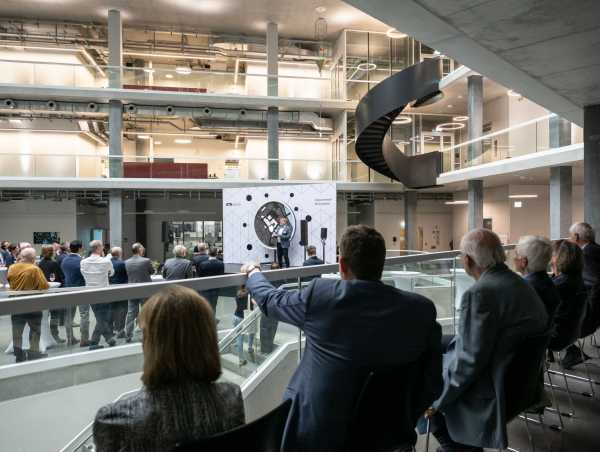 Invitees at the Opening Ceremony, view into the atrium towards the stage with Prof Sven Panke holding his speech