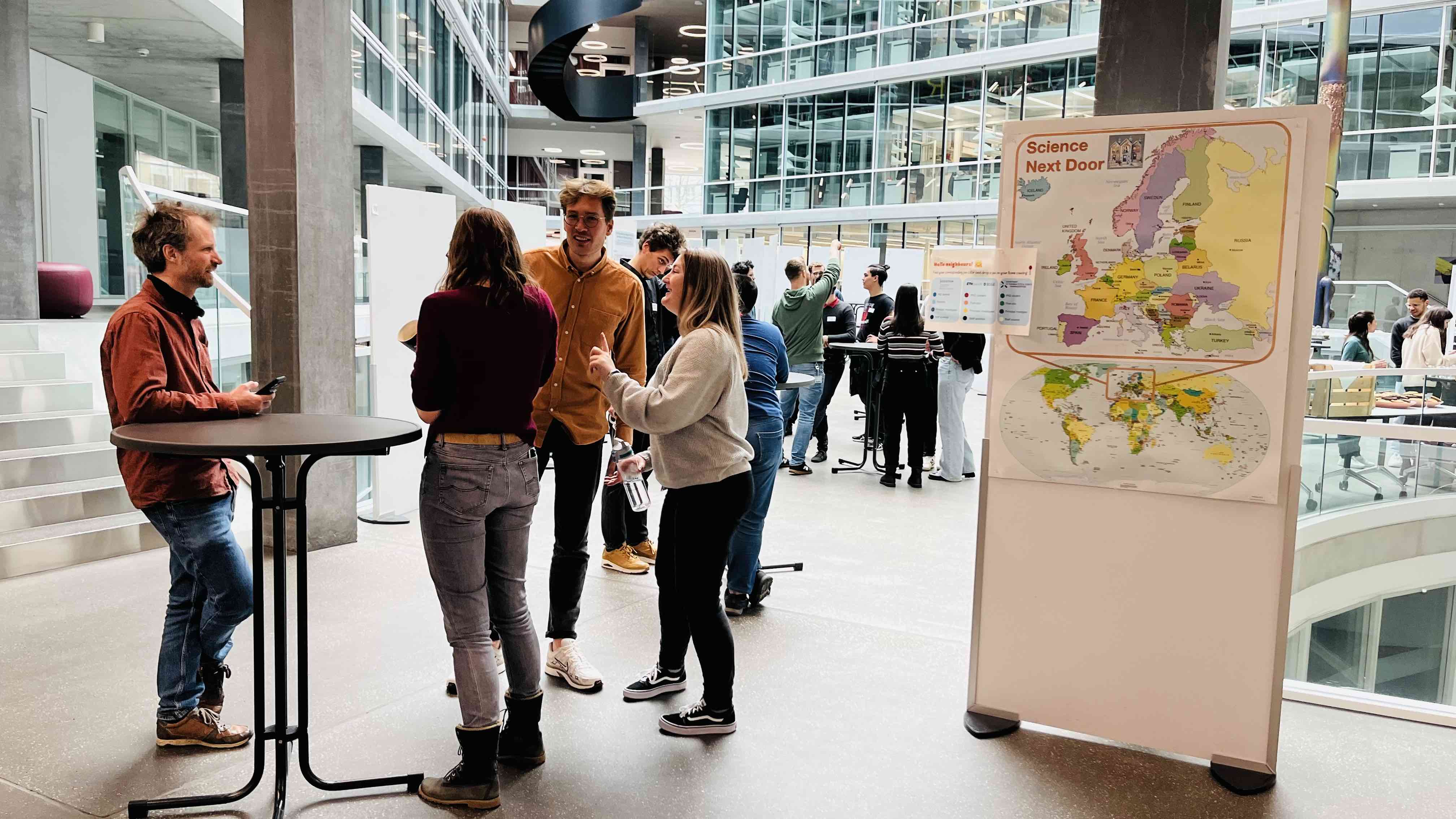 Enlarged view: photo of young scientists mingling at the poster session