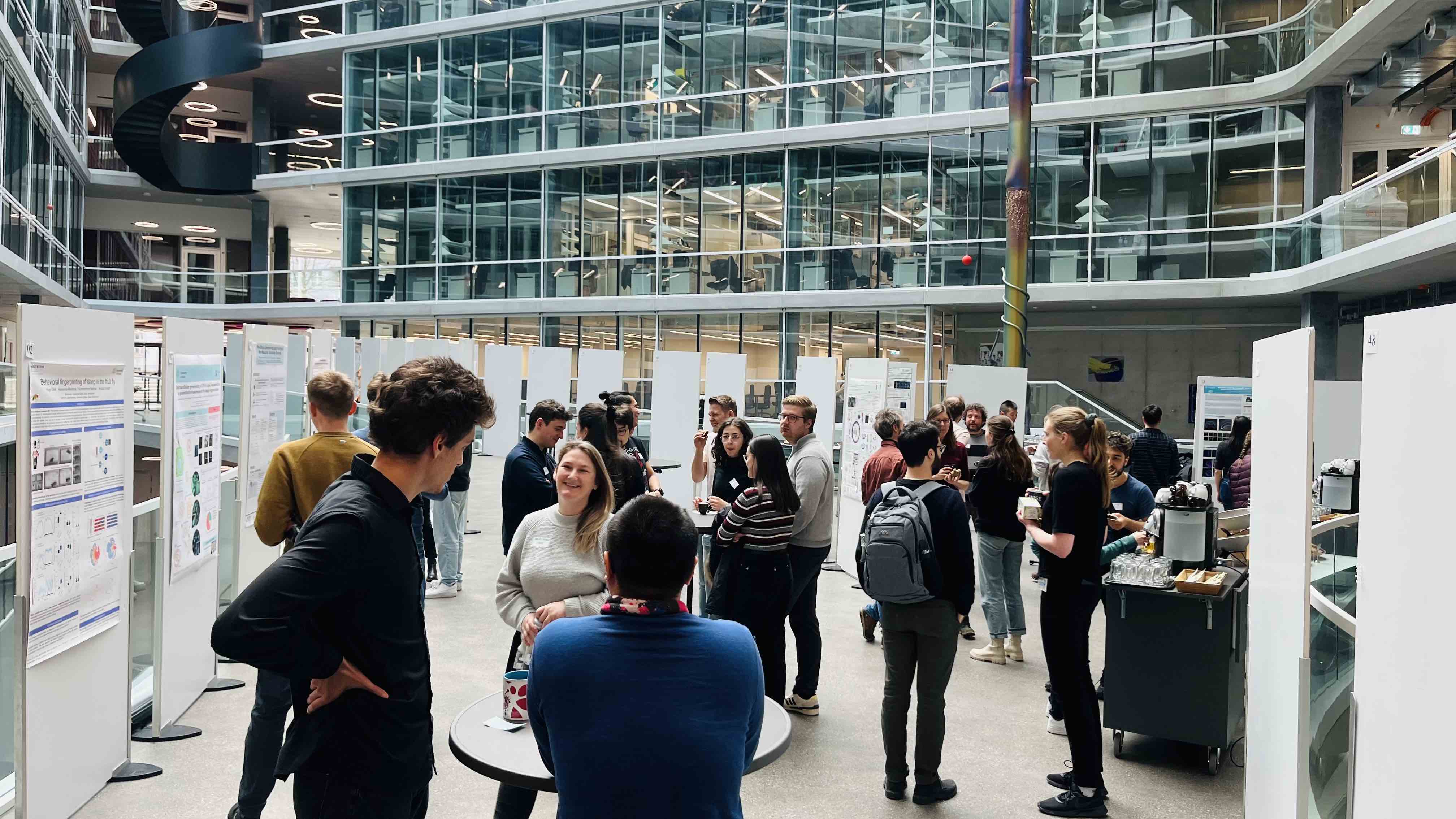 Enlarged view: photo of young scientists mingling at the poster session