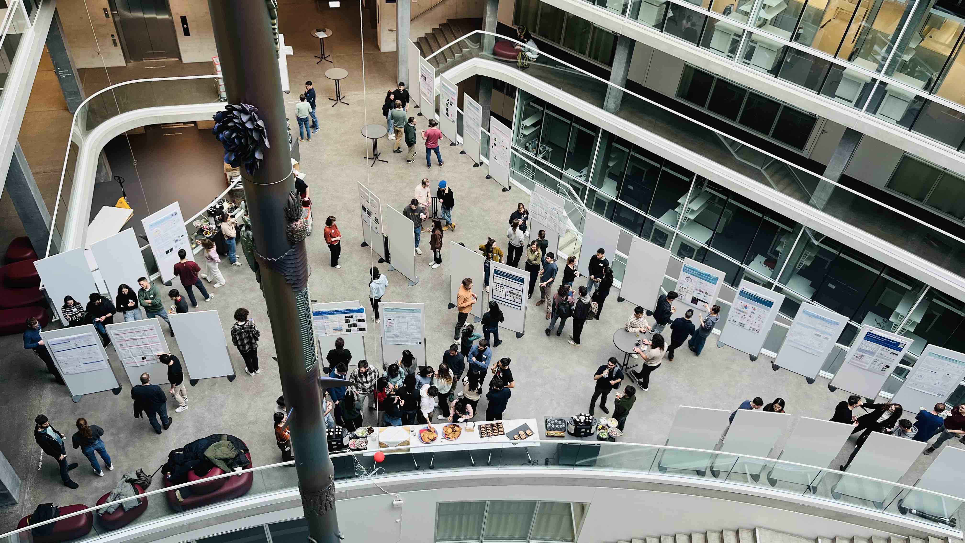 Enlarged view: photo of young scientists mingling at the poster session